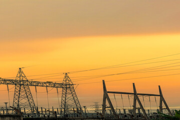 Vertical High voltage pole electric wiring distribution landscape energy engineering. Electricity energetic sunset green mountain in countryside. Vertical Electric power energy engineering industrial