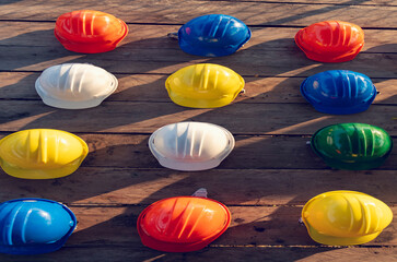 Construction hard hat vertical safety tools equipment workers in construction site engineering protection head on wood wall. Engineering Construction Vertical Many hard hat row helmet with copy space