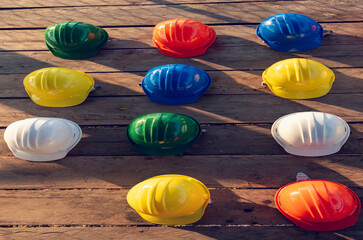 Construction hard hat vertical safety tools equipment workers in construction site engineering protection head on wood wall. Engineering Construction Vertical Many hard hat row helmet with copy space