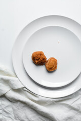Overhead view of Akara on a white plate, top view of Brazilian acaraje fried beans cake on a plate