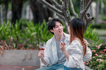 Obraz premium Asian Couple Enjoying Red Wine Together