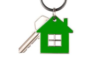 A silver key attached to a green house-shaped keychain on a keyring against a white background