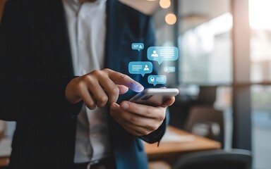 Businessman in a suit using a smartphone for social media communication. Digital icons for messages and profiles float above the modern device.
