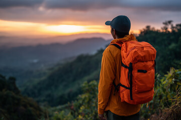 Reflective Male Hiker in Bright Orange Jacket and Cap Facing Mountain Sunrise – Serene Outdoor Adventure Aesthetic