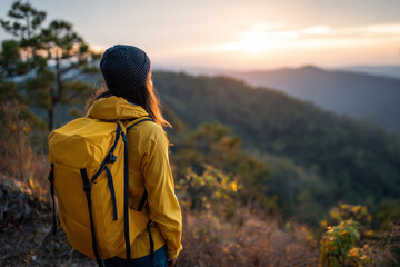 Adventurous Woman in Yellow Jacket and Knit Beanie Watching Sunrise Over Forested Hills – Peaceful Nature Aesthetic