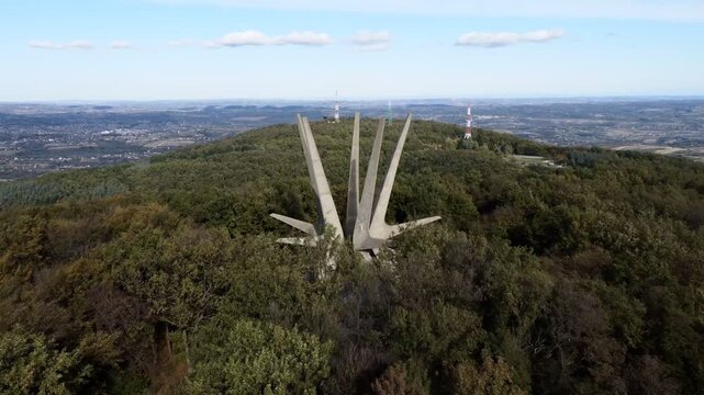 Kosmaj mountain memorial monument atop wooded hill under blue sky, aerial view serbia. g.