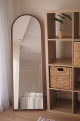 Full-length mirror and natural decor in a stylish room