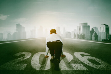 Businessman on a starting line with the year 2026, ready to run a race in the city.