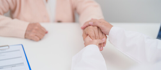 senior woman consulting with doctor in hospital. Elderly patient talking and sharing disease. Doctor listens, asking question and taking note. medical consultation and geriatric Healthcare concept