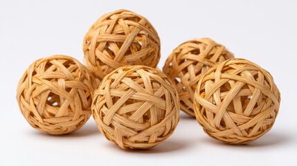 Five intricately woven wicker balls are positioned artistically, highlighting their natural texture and design. This decorative arrangement emphasizes traditional craftsmanship and artistry.