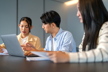 Obraz premium Asian business team brainstorming together, strategic planning with tablet in office, inclusive workplace, financial strategy, b2b startup innovation, teamwork seminar and corporate collaboration