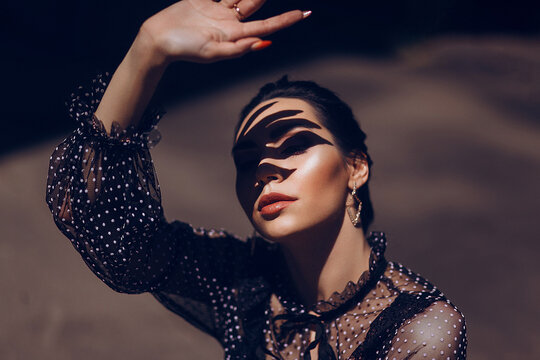 Woman's Face with Shadow Traces from Her Hand, Dramatic Play of Light and Shadow