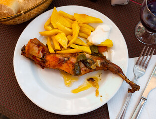 Appetizing dish of stewed rabbit with spices and boiled potatoes