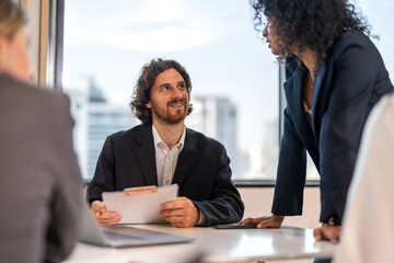 Diverse business team brainstorming together, strategic planning with laptop in office, inclusive workplace, financial strategy, b2b startup innovation, teamwork seminar and corporate collaboration