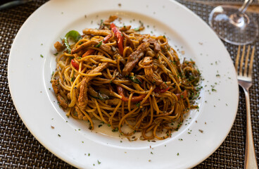 Filling meal of noodles fried with beef asian style