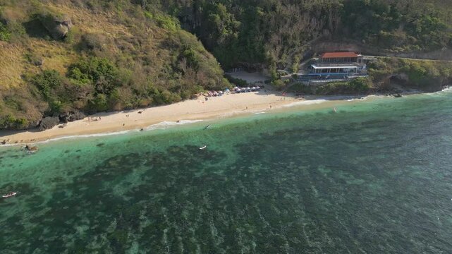 Hidden Beach At Bottom Of Uluwatu Cliffs Bali Indonesia Drone Pan Shot 4K 60FPS