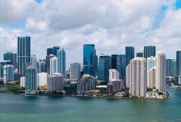 Fototapeta premium Aerial view of Brickell skyline in downtown Miami. Modern skyscrapers rise above Biscayne Bay. Scenic panorama of Miamis financial district.