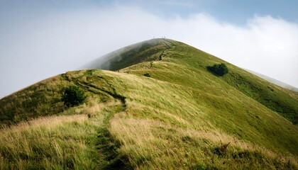Hiking trail through rolling green hills in a misty mountain landscape Adventure.