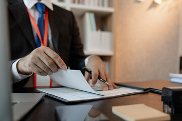 a businessman is reviewing accounting and financial statistics documents in his private office, the statistician prepares various charts and documents for a meeting