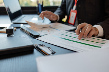 a businessman reviews the company's financial documents in his office, the accountant is rushing to check the figures in the documents before submitting them to the tax office