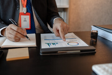Fototapeta premium an accounting and financial officer is working on documents in the office, a businessman is reviewing his company's historical budget statistics, finance, marketing