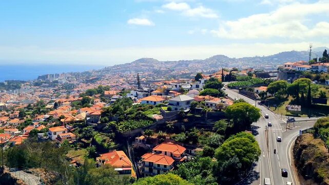 July 15, 2025. Funchal, Portugal. Picturesque view of the city with traditional terracotta roofs. Cityscape surrounded by lush greenery