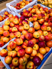 Freshly harvested apples displayed in woven baskets at a local farmers market during autumn season