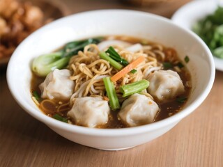 Indonesian baso with vegetable and noodle in a white bowl
