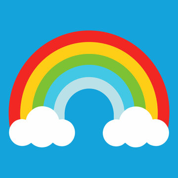 Vibrant rainbow arch with fluffy clouds on a blue sky