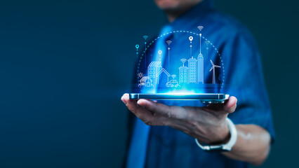Businessman holding smartphone with smart city digital icons for real estate technology and urban connectivity transformation concept