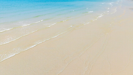 Beach sand background for summer vacation concept. Beach nature and summer seawater with sunlight light sandy beach Sparkling sea water	