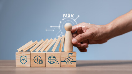 Business risk prevention strategy with hand placing wooden figure stopping dominoes on icon blocks,...