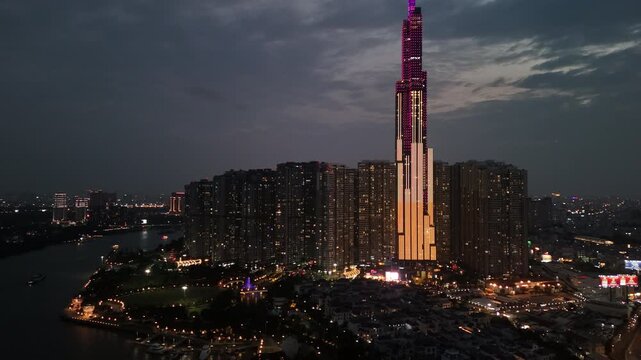 Ho Chi Minh City, Vietnam: 4K Night Aerial Drone Footage of Landmark 81 Skyscraper, Central Park, Illuminated Skyline, Saigon River, Vibrant City Lights, nightlife, and busy traffic