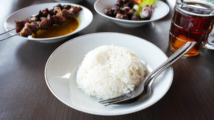 Sate Klatak, tender lamb satay skewered on bicycle spokes, served on yellow curry soup. Popular street food in Yogyakarta
