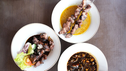 Sate Klatak, tender lamb satay skewered on bicycle spokes, served on yellow curry soup. Popular street food in Yogyakarta
