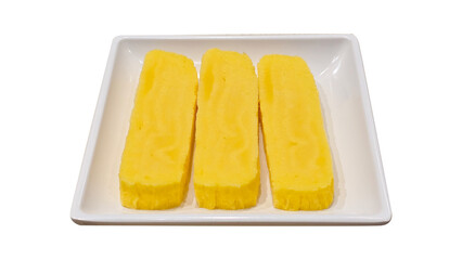 Three rectangular slices of tamagoyaki, a sweet Japanese rolled omelette, served neatly on a square white ceramic dish for culinary use 