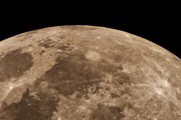 Close-up telescope image of the moon’s cratered surface with mare