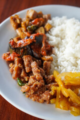 **Nasi Rames, Indonesia, captured on August 6, 2025. Mixed rice dish with assorted side dishes like tempeh, vegetables, sambal, and curry, showcasing a colorful and flavorful everyday Indonesian meal