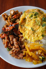 **Nasi Rames, Indonesia, captured on August 6, 2025. Mixed rice dish with assorted side dishes like tempeh, vegetables, sambal, and curry, showcasing a colorful and flavorful everyday Indonesian meal
