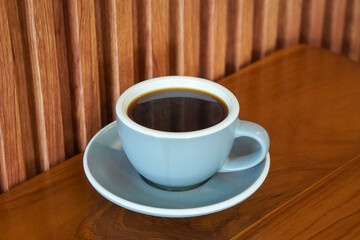 Hot Americano, Indonesia, captured on August 6, 2025. A bold black coffee served in a clean ceramic cup, rich aroma rising with steam, perfect for a minimalist café scene or a calm morning at work