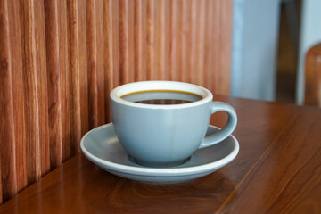 Fototapeta premium Hot Americano, Indonesia, captured on August 6, 2025. A bold black coffee served in a clean ceramic cup, rich aroma rising with steam, perfect for a minimalist café scene or a calm morning at work
