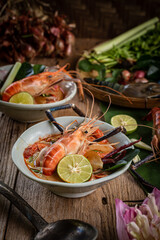 Thai style creamy Tom Yum Goong soup with herbs, lemongrass and kaffir lime leaves