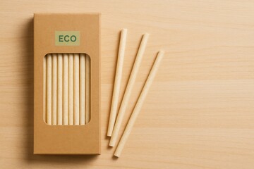 Biodegradable drinking straws made from rice or wheat in eco kraft packaging with green label - sustainable product concept with space for text.