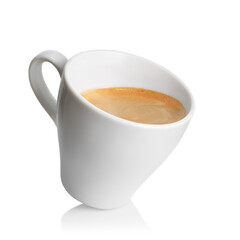 Small inclined espresso cup filled with freshly brewed coffee, featuring rich crema on top, isolated on white background