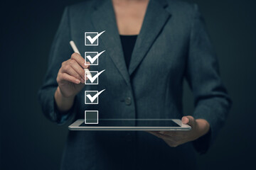 Business performance checklist concept Young business woman using laptop surveys online checklist Complete the digital form checklist via the internet..