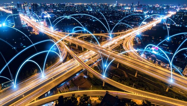 Night aerial of a complex highway interchange with glowing lines suggesting network connections - Powered by Adobe