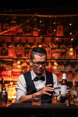 Bartender is pouring whiskey into a glass in a restaurant	