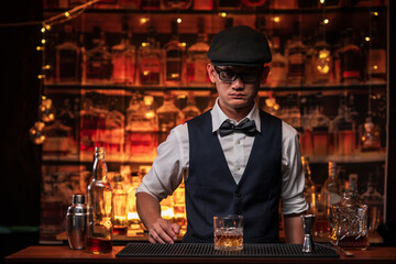 Bartender is pouring whiskey into a glass in a restaurant