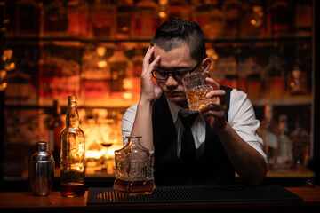 Bartender is pouring whiskey into a glass in a restaurant	