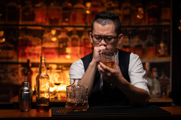 Bartender is pouring whiskey into a glass in a restaurant